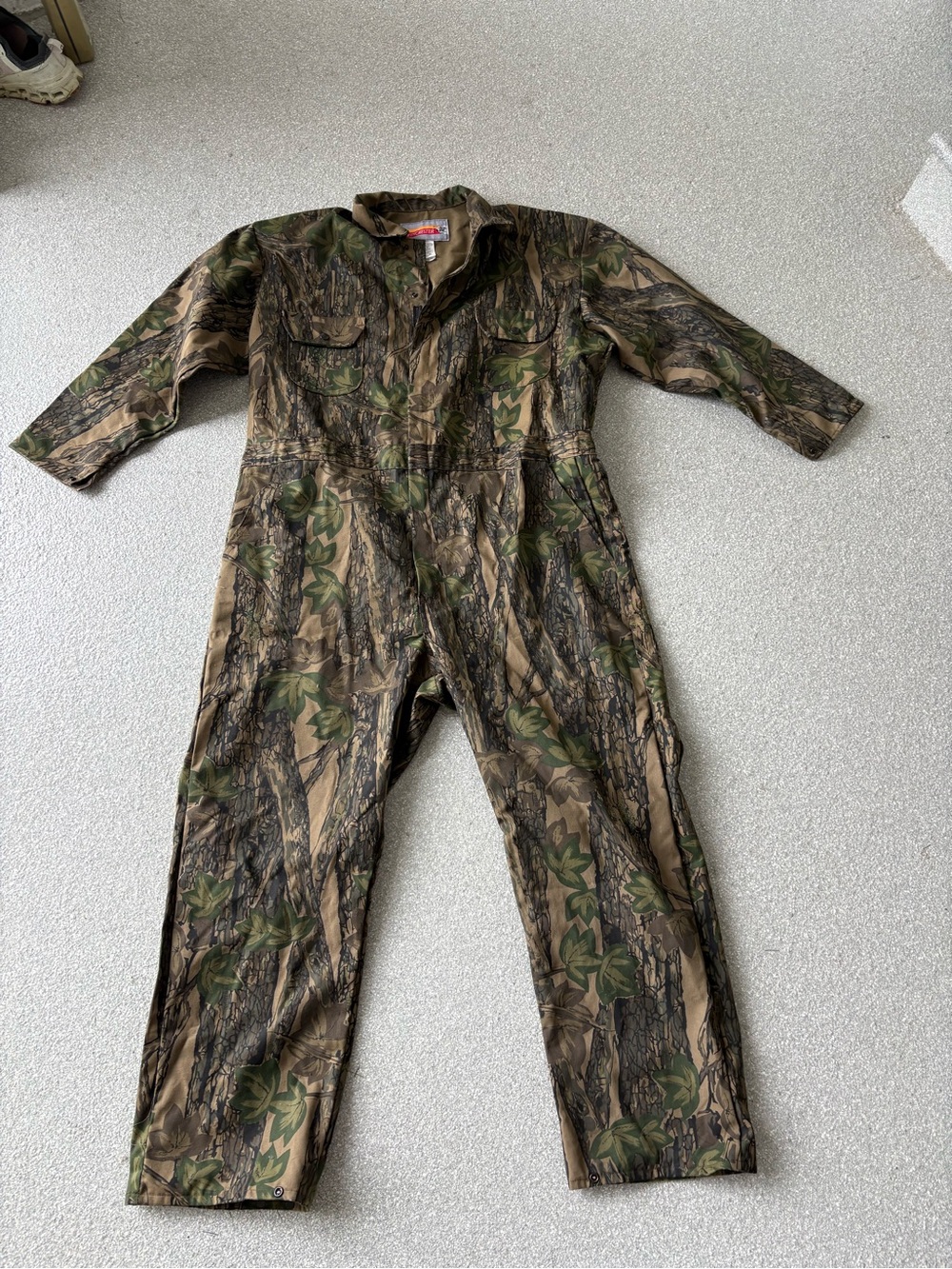 Winchester hunting coveralls featuring a classic green treebark camouflage XXL